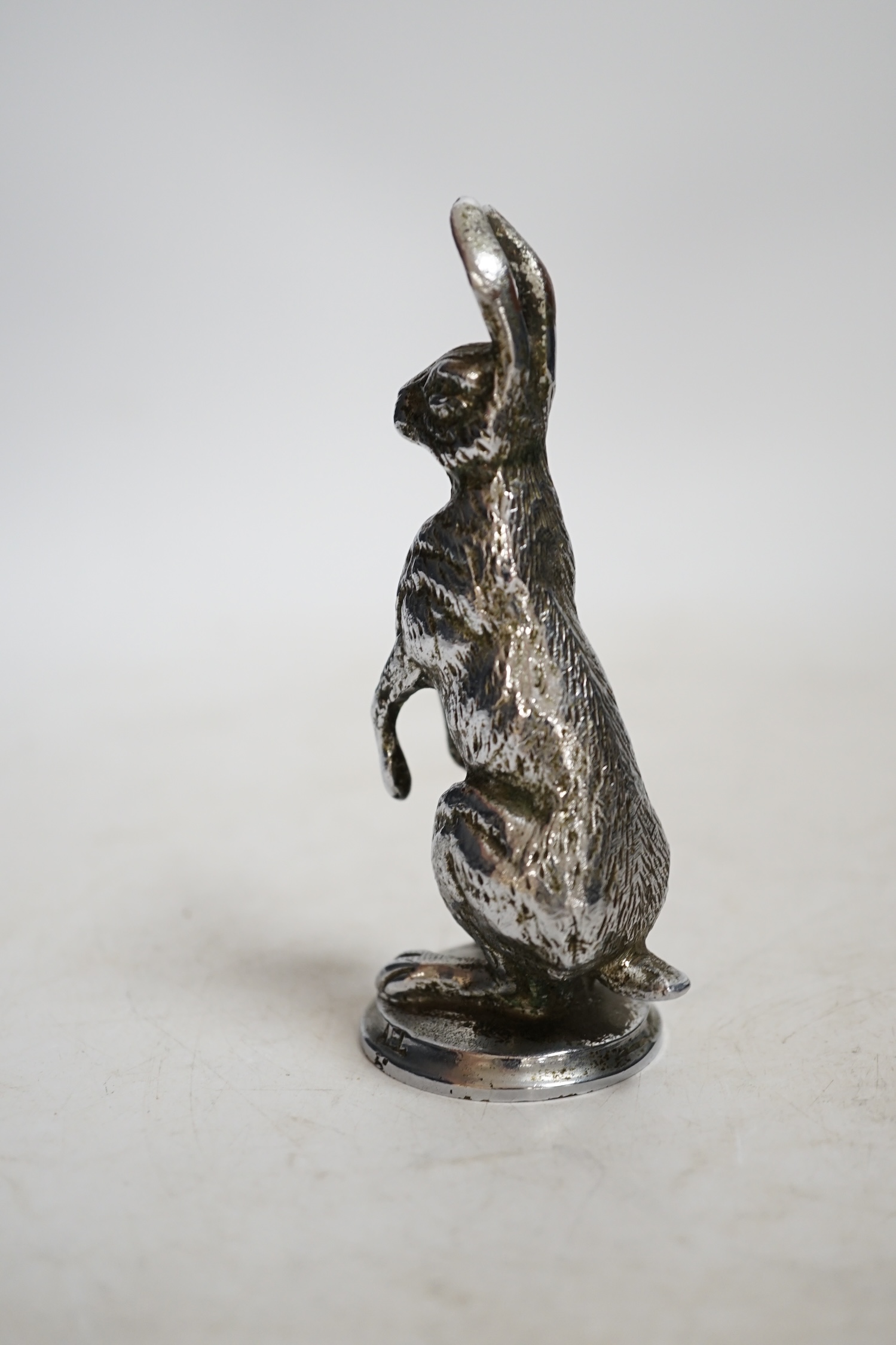 A mid 20th century chromed metal hare car mascot, 11cm high. Condition - good
